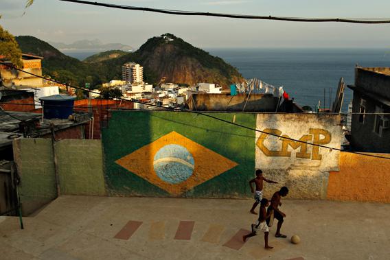 Children play soccer at a square at a favela in Rio de Janeiro February 22, 2013.