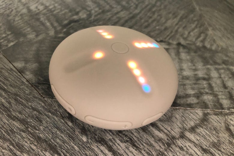 A round beige device with lights on it in a cross formation