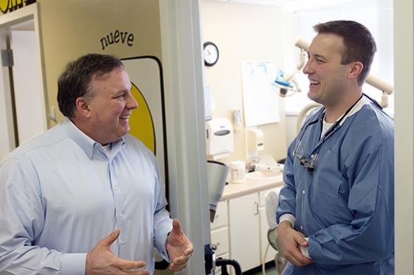 Jeff Parker talking with dentist Dr. Joseph Zanthos.