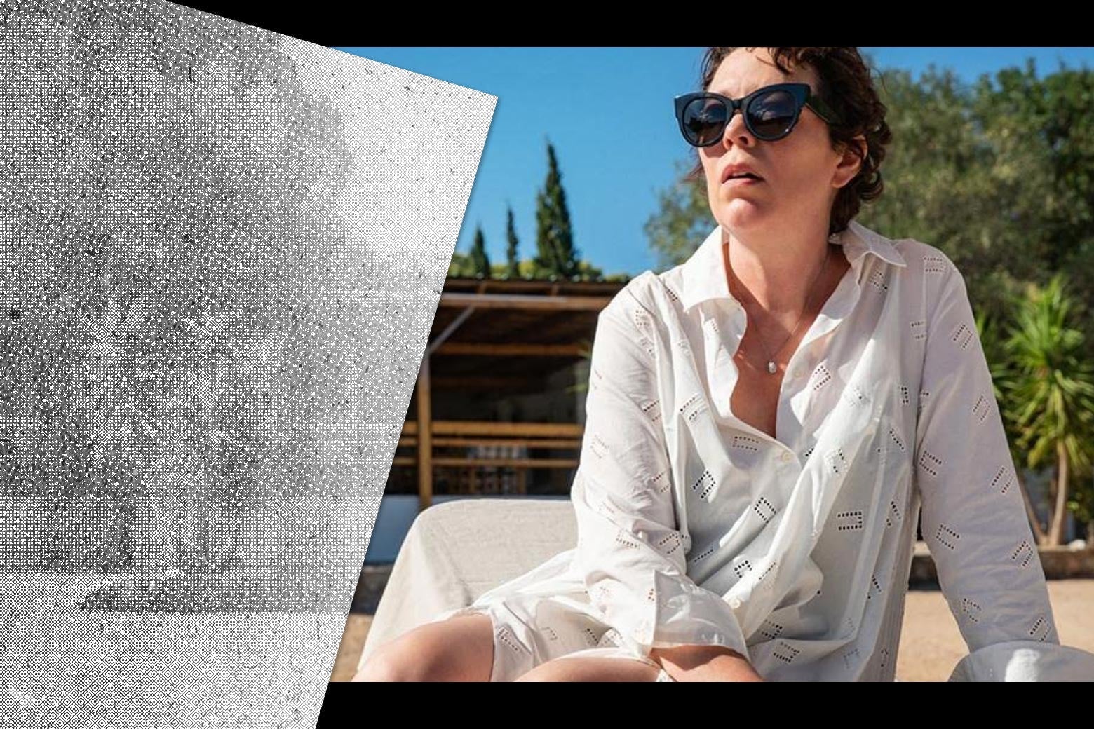 Olivia Colman, wearing a white beach coverup and sunglasses, lounges on a beach.
