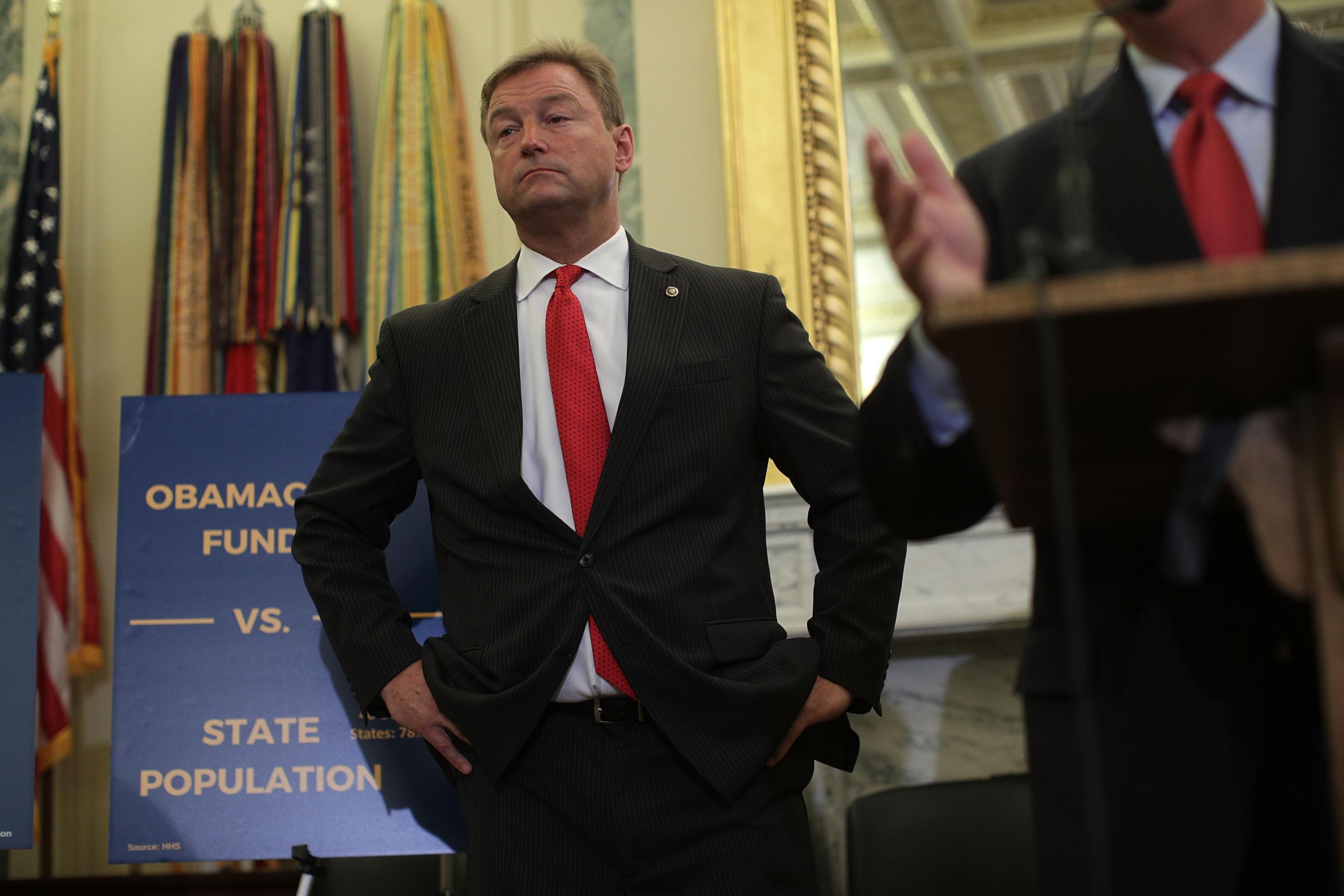 Sen. Dean Heller listens during a news conference on health care Sept. 13 on Capitol Hill.