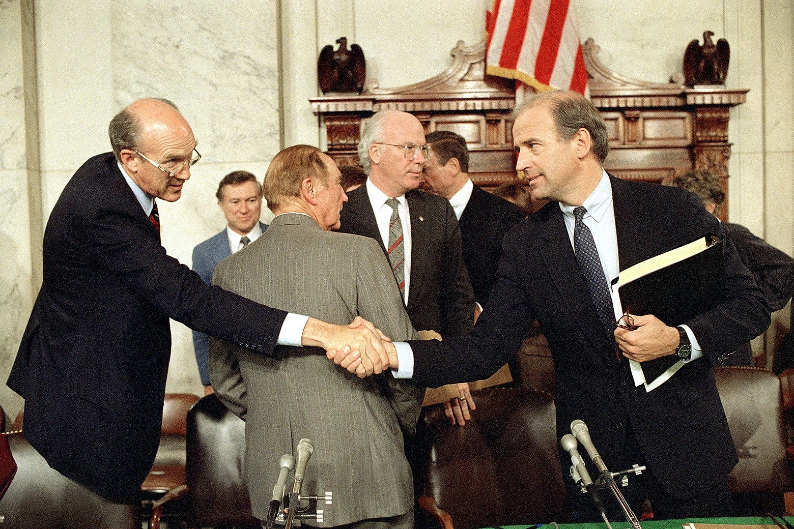 Biden shakes hands with Simpson in the committee room
