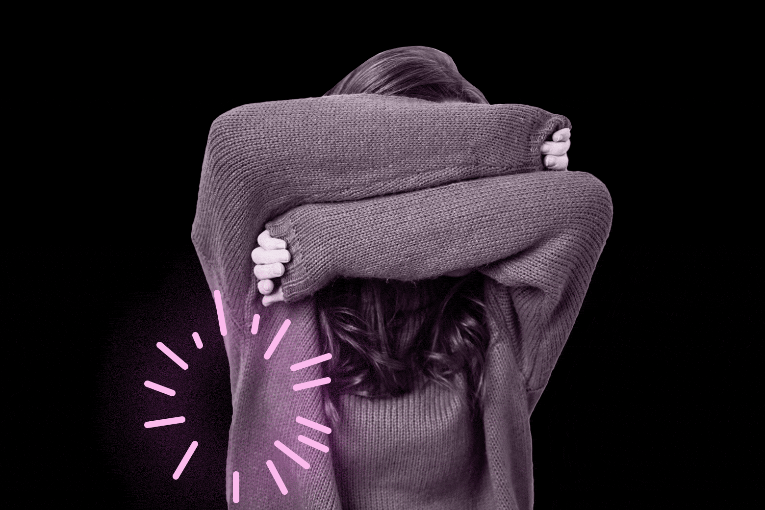 Woman shielding herself with her arms with fireworks going off around her.