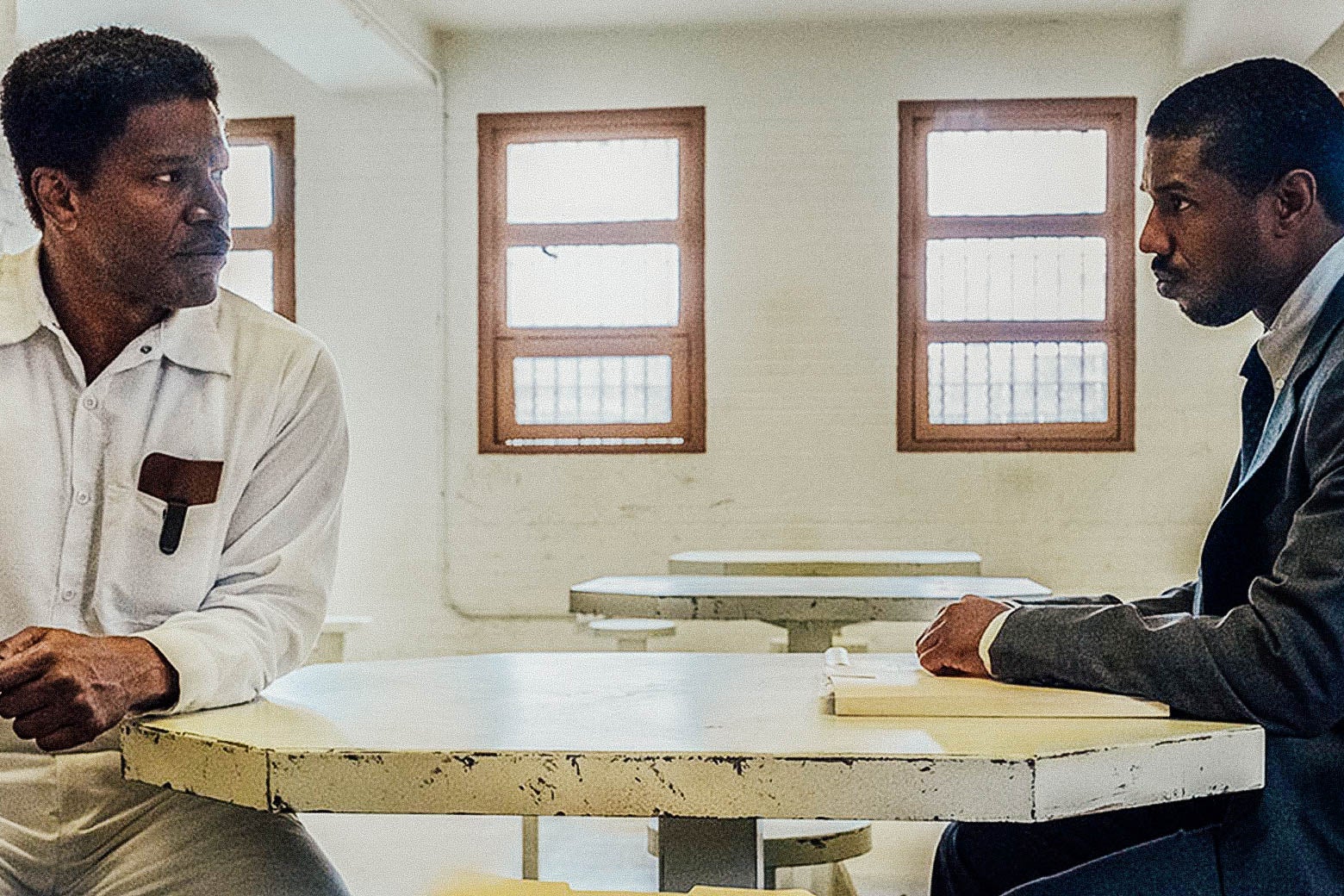 Jamie Foxx and Michael B. Jordan sit across a table from each other in a prison visitation room.