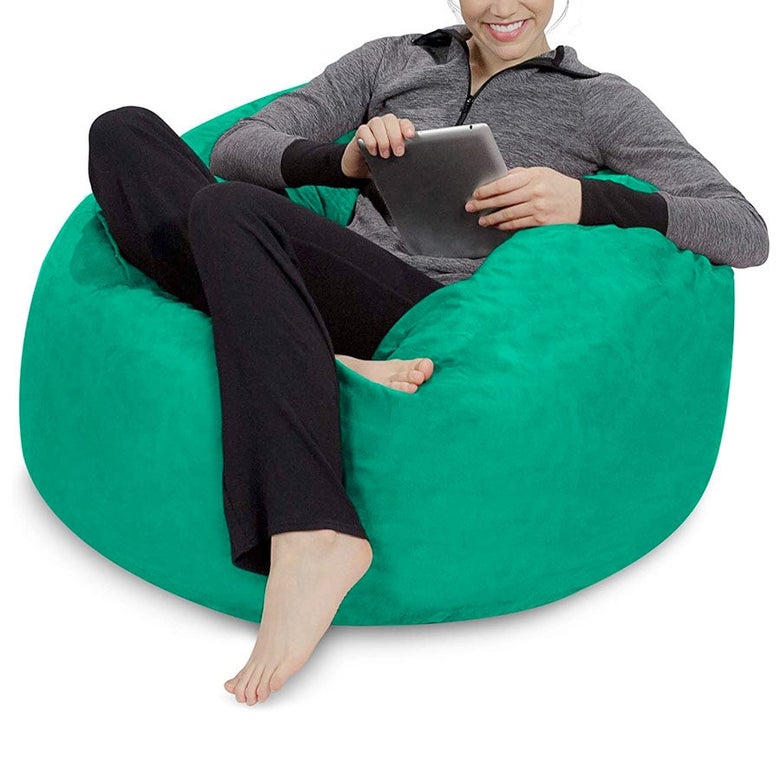A woman sitting in a green beanbag chair.
