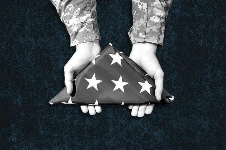 A soldier offering a folded flag.