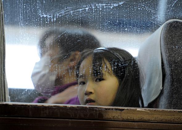 Girl aboard a bus evacuating from Yamagata