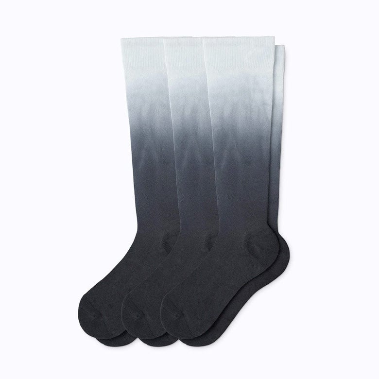 Three pairs of black ombré compression socks.