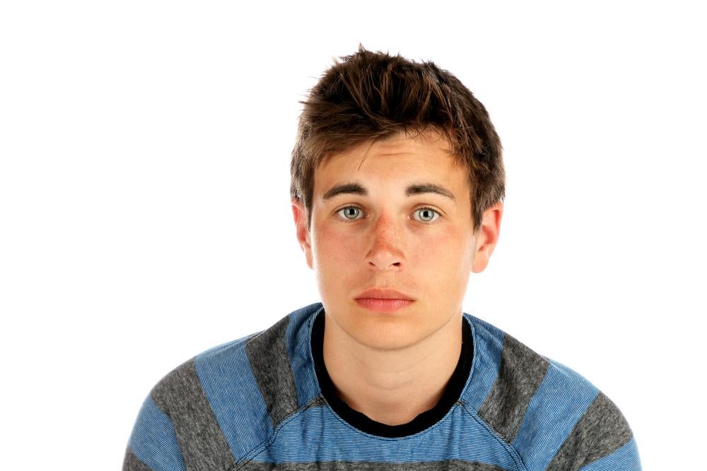 Young man staring at the camera looking vulnerable