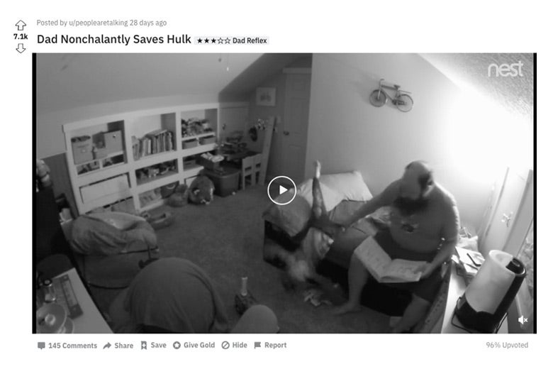 A father catching his child falling off a bed during story time.