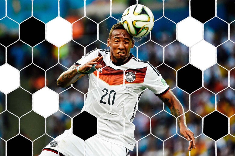 Jerome Boateng grimaces as he heads the ball.