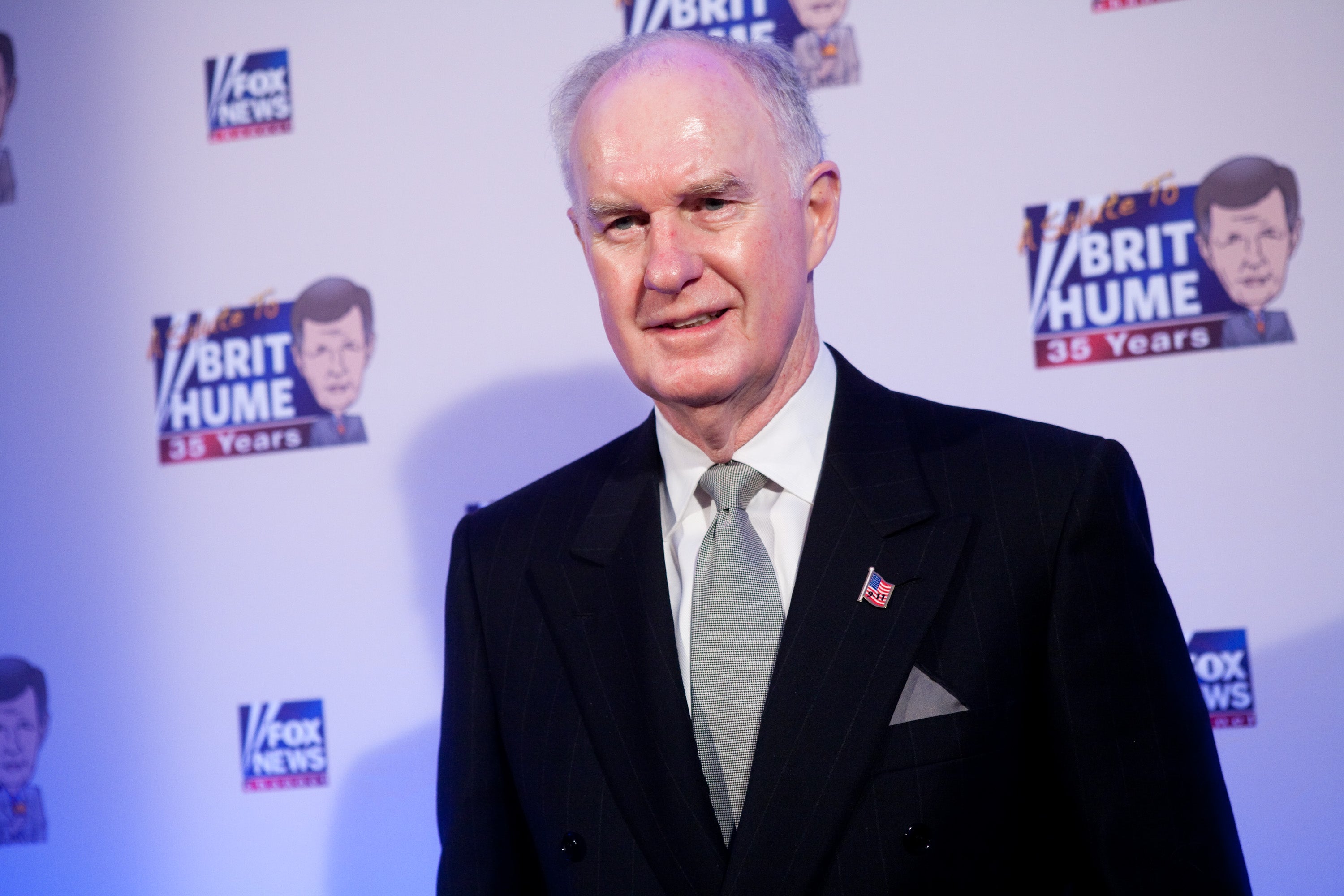 Thomas McInerney in front of Fox News logos at a red-carpet event.