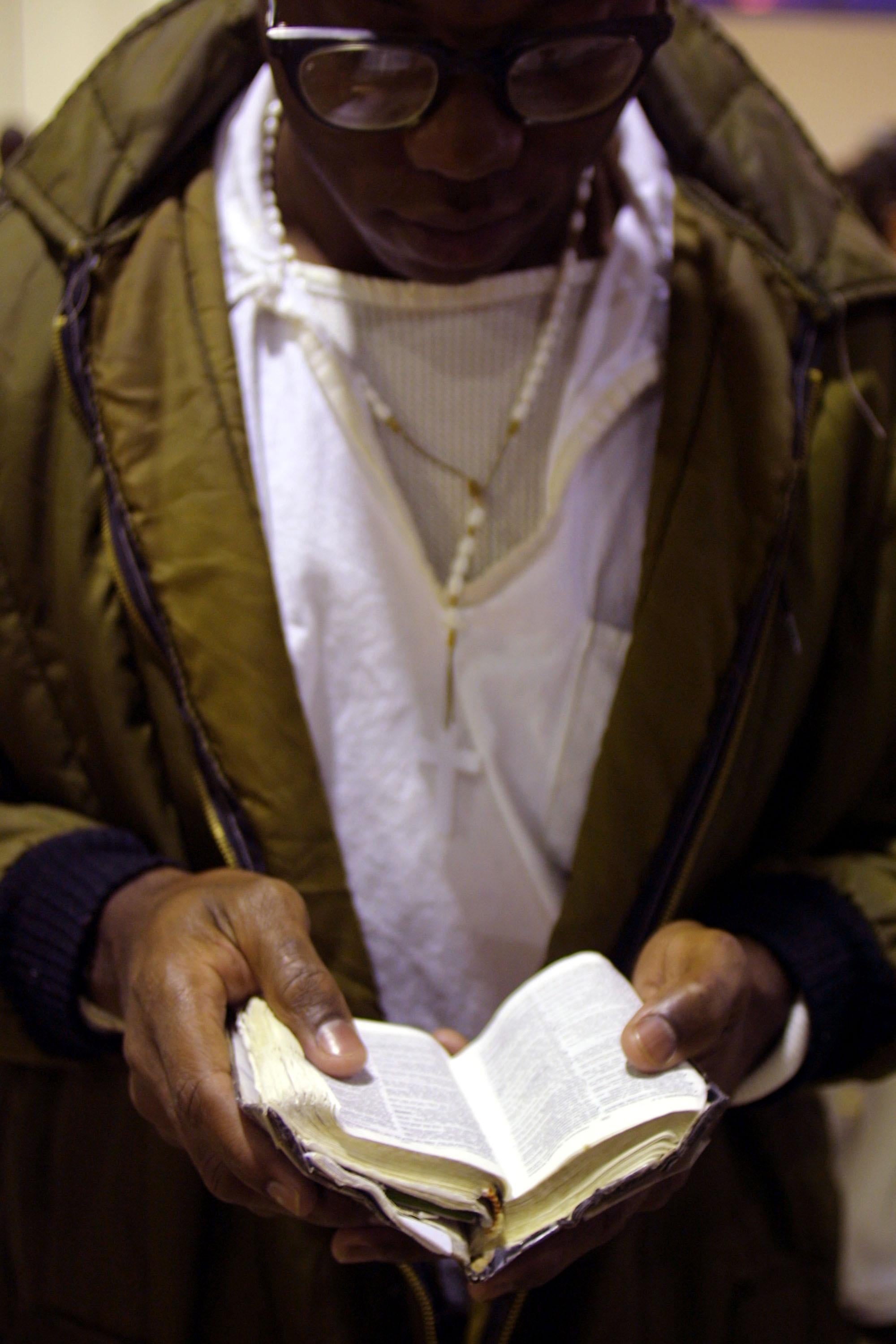 An inmate reads his bible.