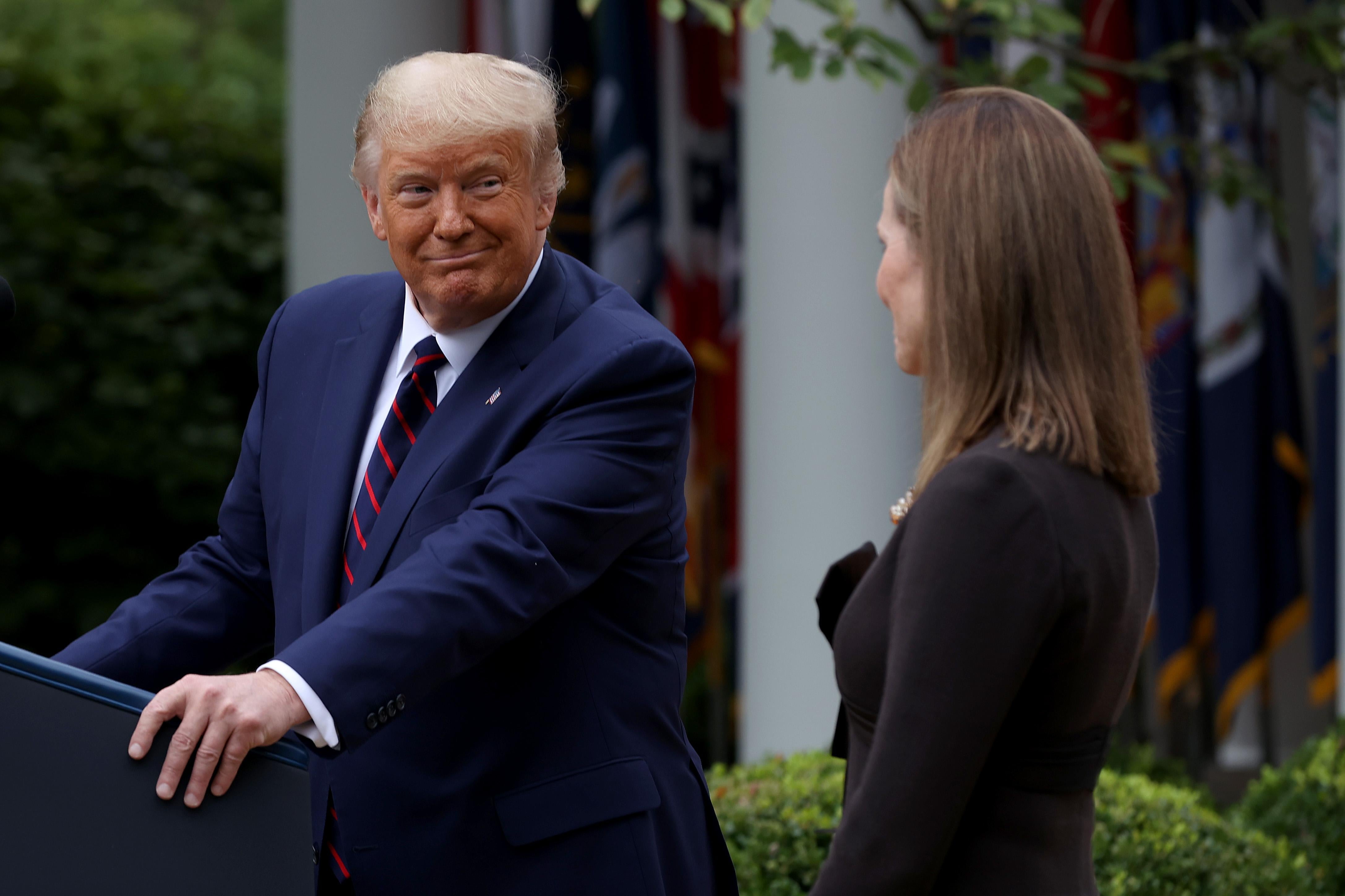 Donald Trump looks at Amy Coney Barrett as he nominates her to serve on the Supreme Court.