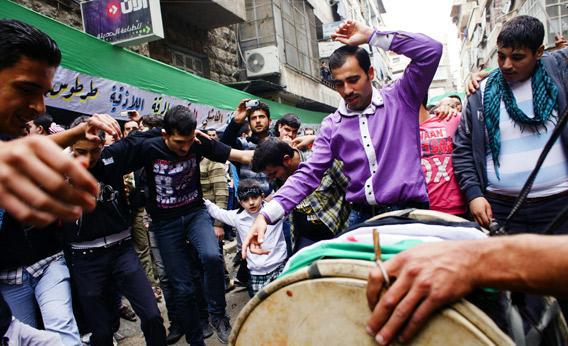 Syrian protesters dance during a demonstration against the regime.