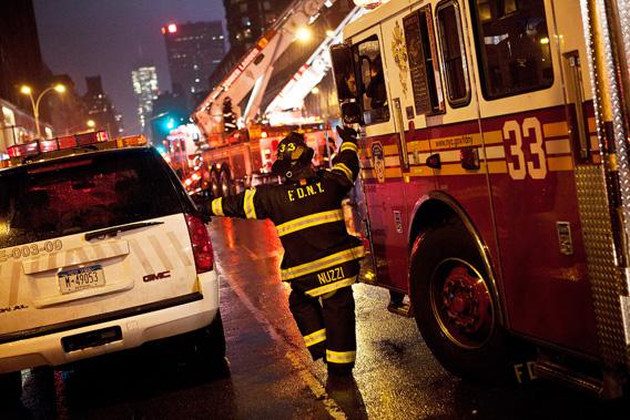 NEW YORK CITY—A firefighter speaks to a colleague while cleaning up damage caused by Hurricane Sandy Oct. 29, 2012