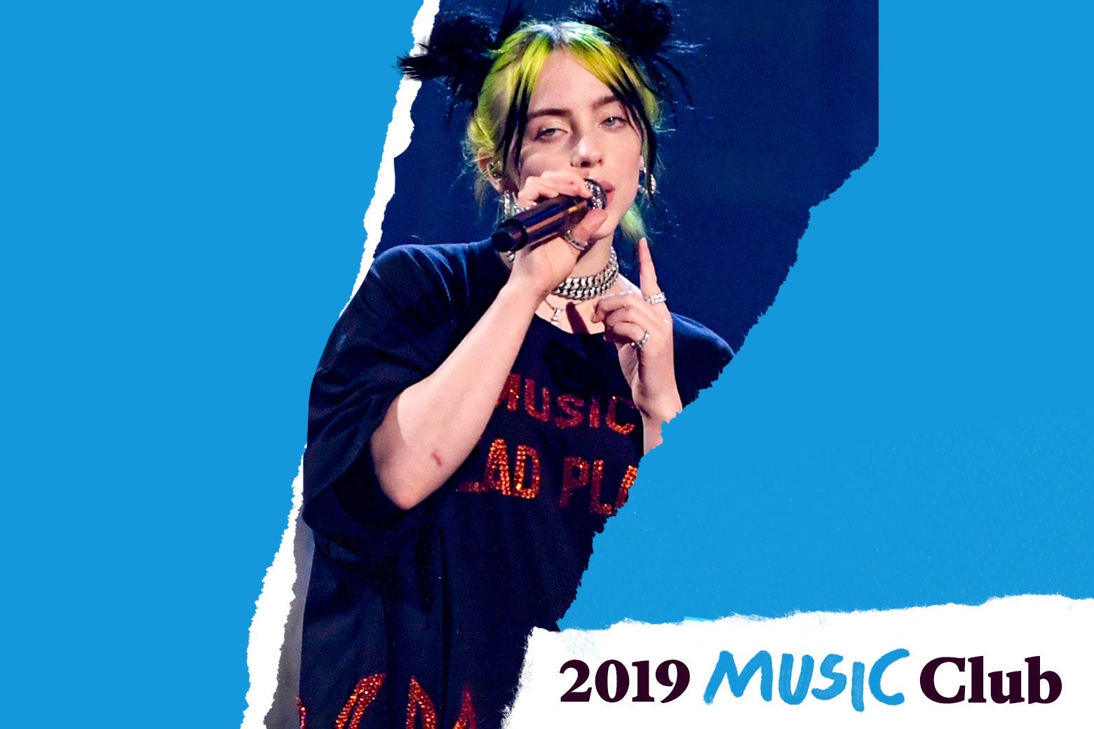 Billie Eilish performs in a shirt that says NO MUSIC ON A DEAD PLANET in sparkly letters. Text in the corner says 2019 Music Club.