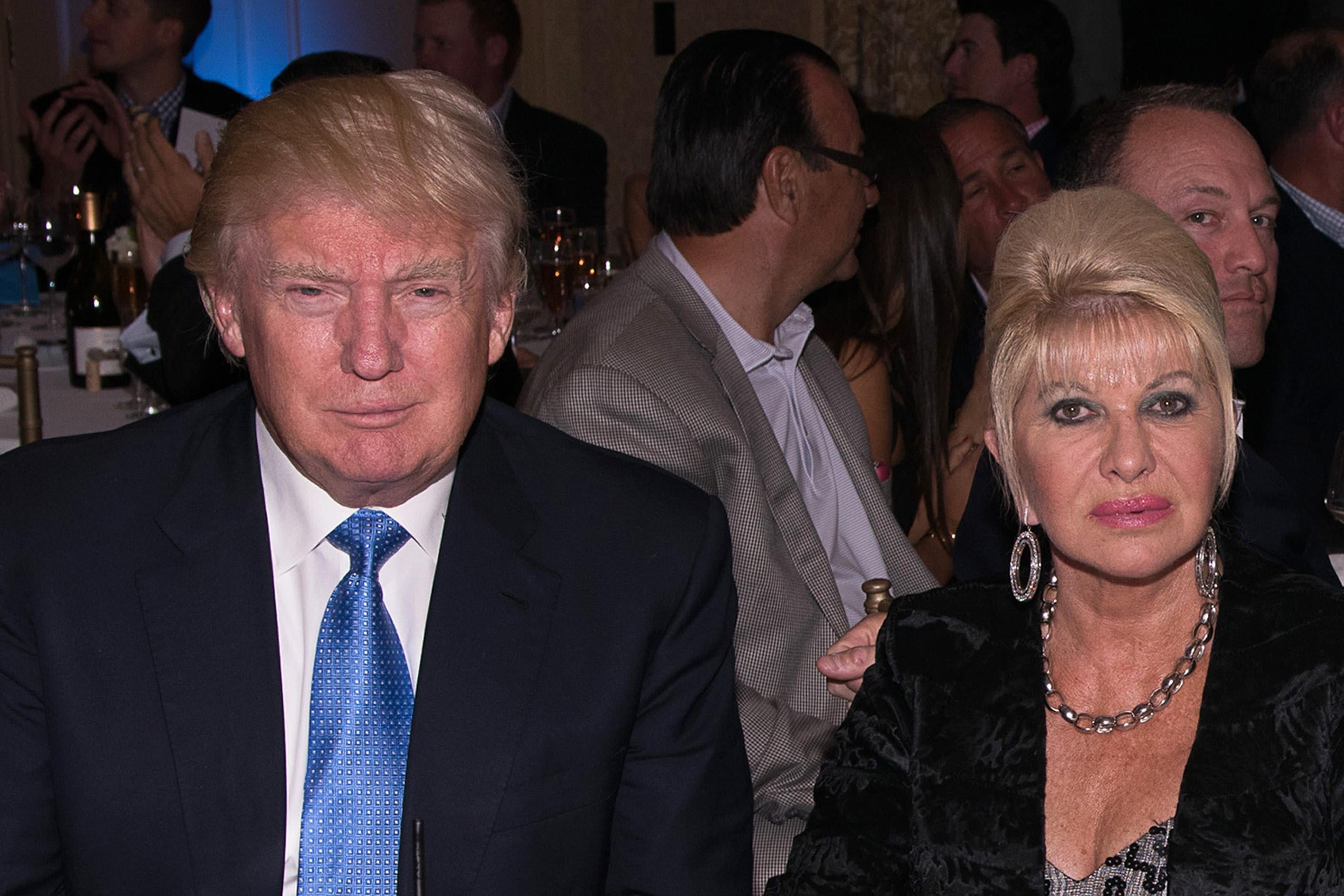 A photo of Donald Trump and Ivana Trump, sitting next to each other, in 2014 at the Eric Trump 8th Annual Golf Tournament at Trump National Golf Club in New York.