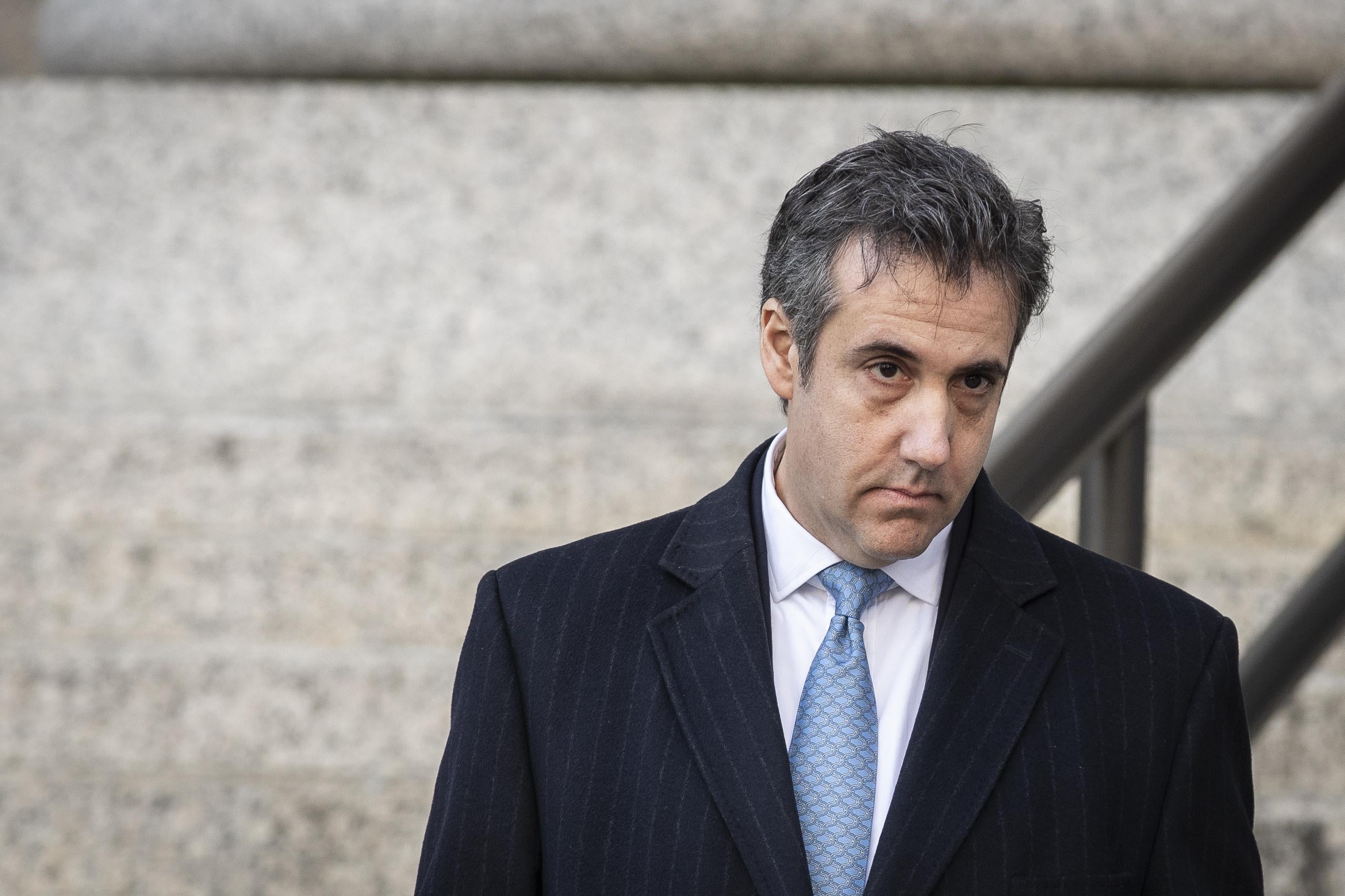 A dejected- or exhausted-looking Michael Cohen, appears to stare out of focus and lost in thoughts.