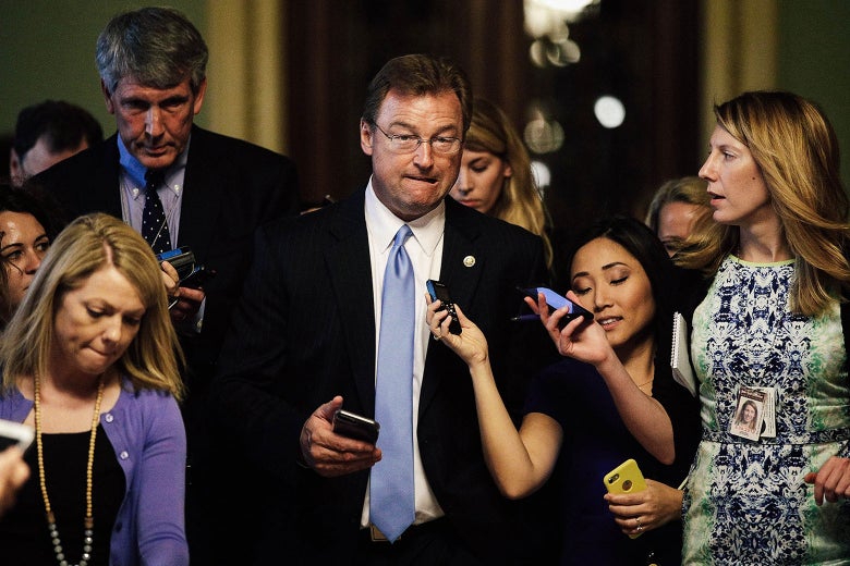 Nevada Sen. Dean Heller is surrounded by members of the media while on his way to view the details of a new health care bill on July 13, 2017