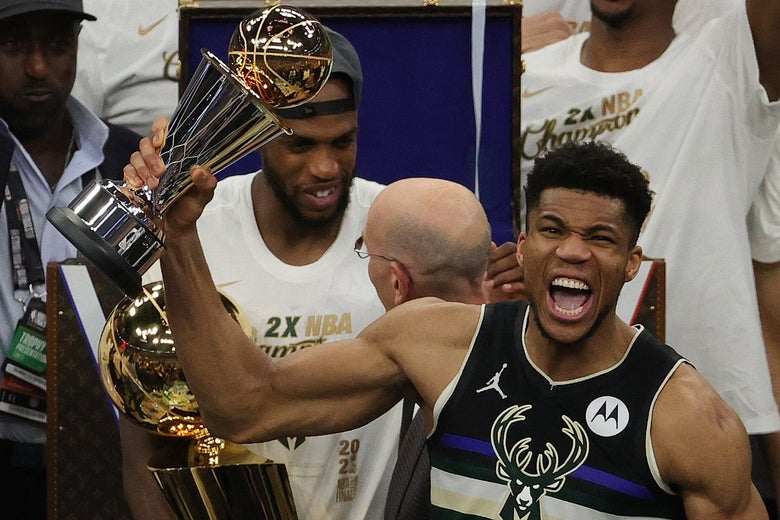 MILWAUKEE, WISCONSIN - JULY 20: Giannis Antetokounmpo #34 of the Milwaukee Bucks celebrates winning the Bill Russell NBA Finals MVP Award after defeating the Phoenix Suns in Game Six to win the 2021 NBA Finals at Fiserv Forum on July 20, 2021 in Milwaukee, Wisconsin. NOTE TO USER: User expressly acknowledges and agrees that, by downloading and or using this photograph, User is consenting to the terms and conditions of the Getty Images License Agreement.  (Photo by Jonathan Daniel/Getty Images)