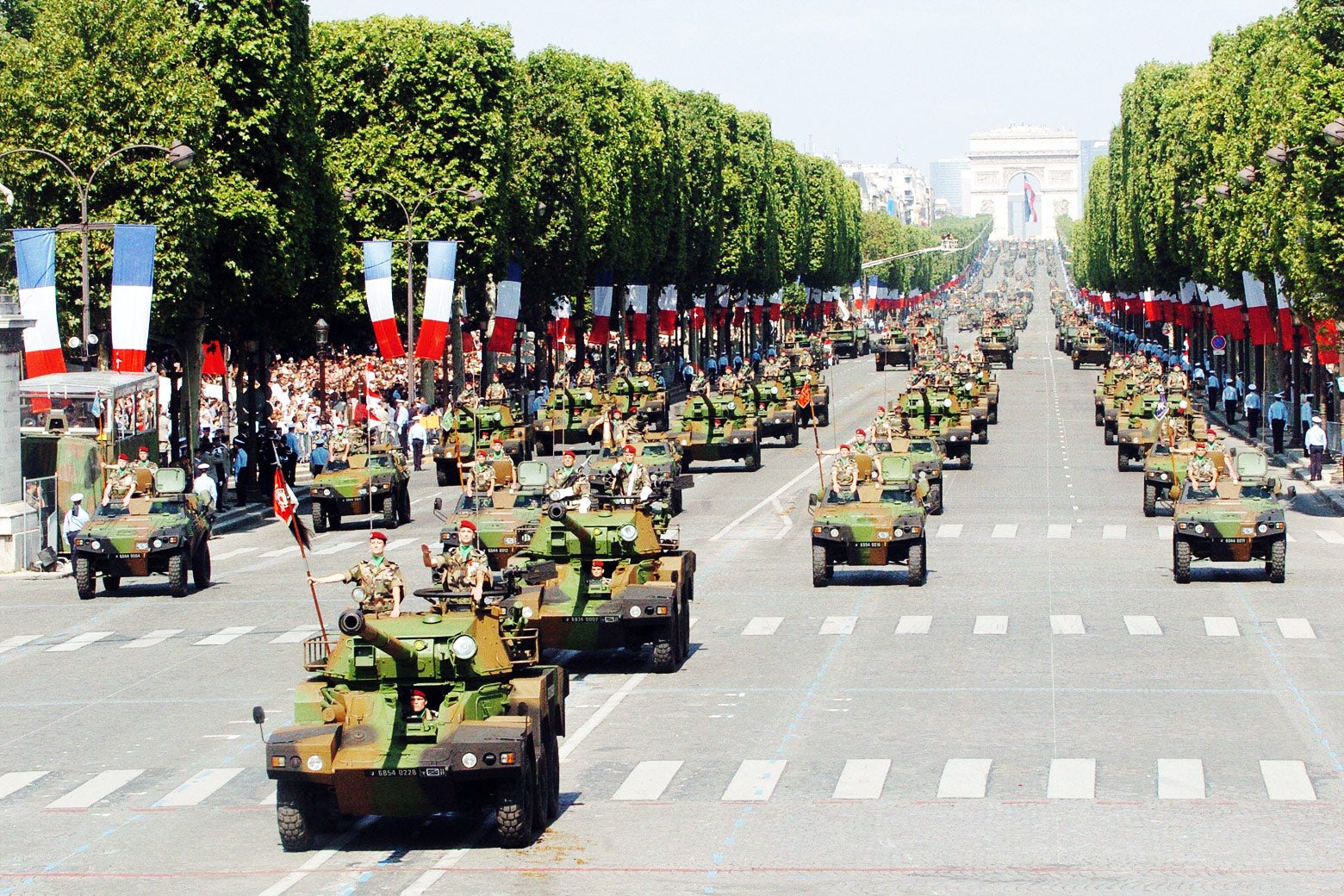 French armored vehicles roll down the Champs-Élysées in Paris during the the annual Bastille Day military parade on July 14, 2004.