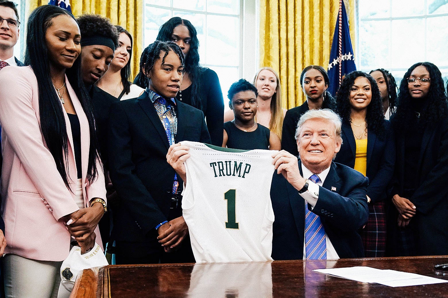 The Baylor women's basketball team stand around Trump in the Oval Office.
