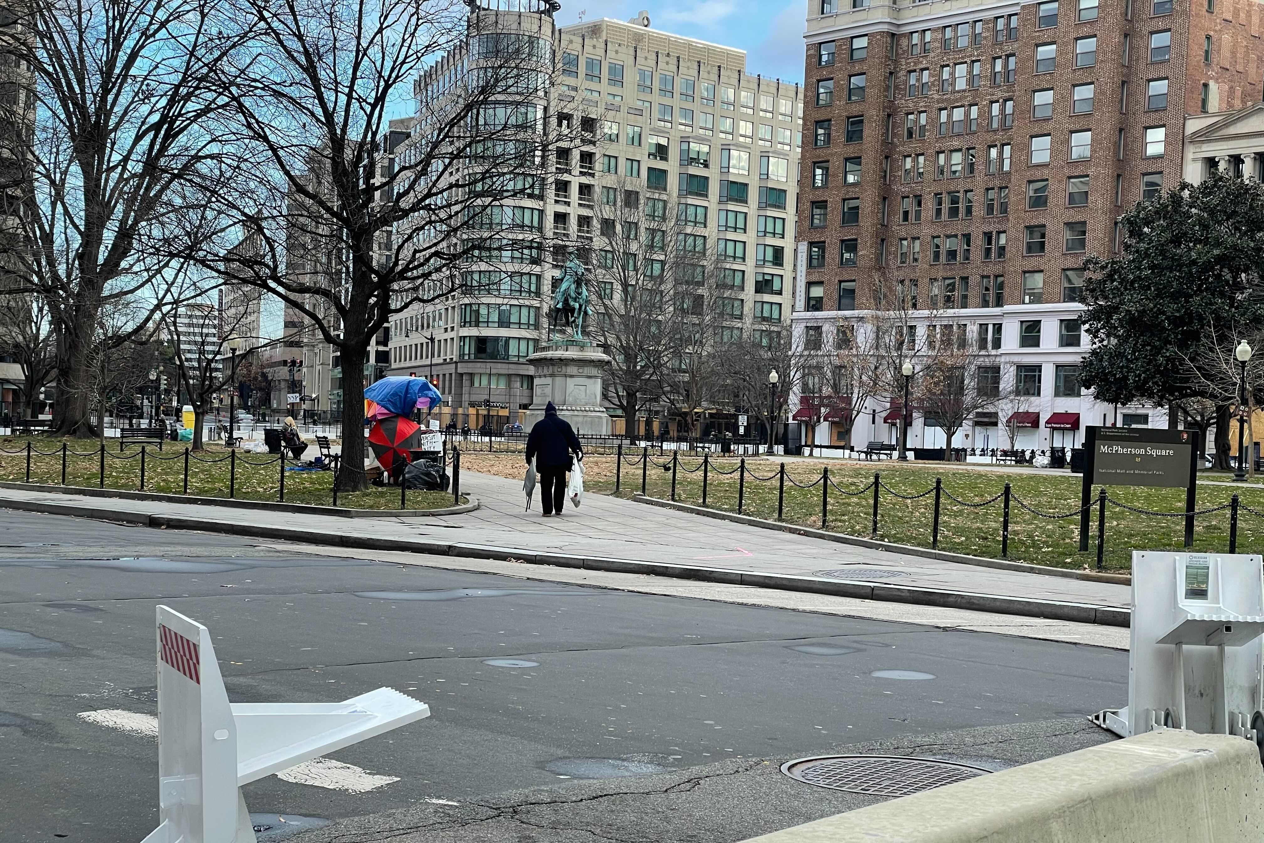 A lone Trump supporter walks off in the distance in D.C.