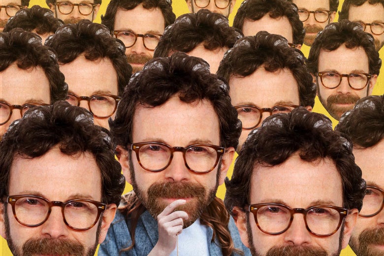 A person holding up a cutout of Charlie Kaufman’s head over his own, surrounded by other images of Kaufman’s head.