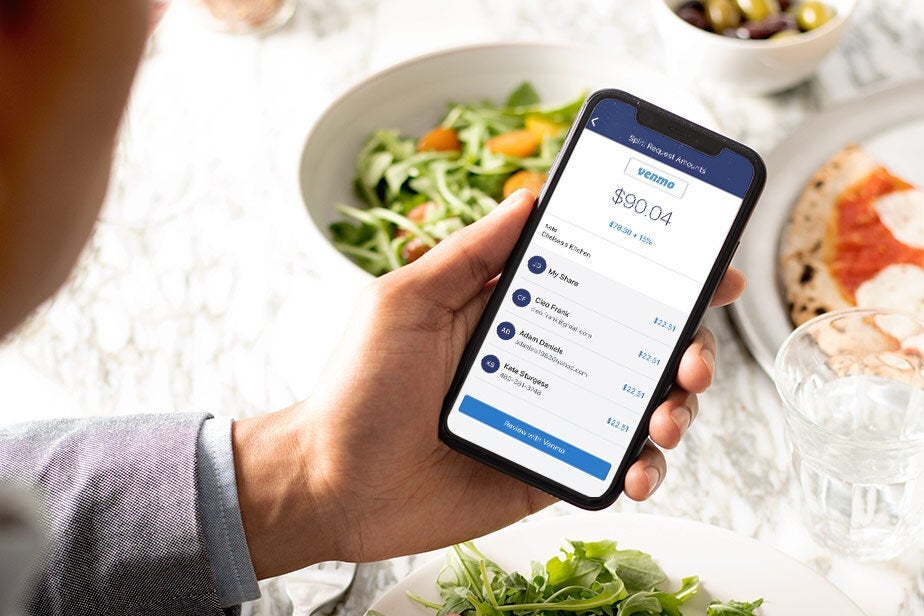 The Venmo app on a smartphone above food. 