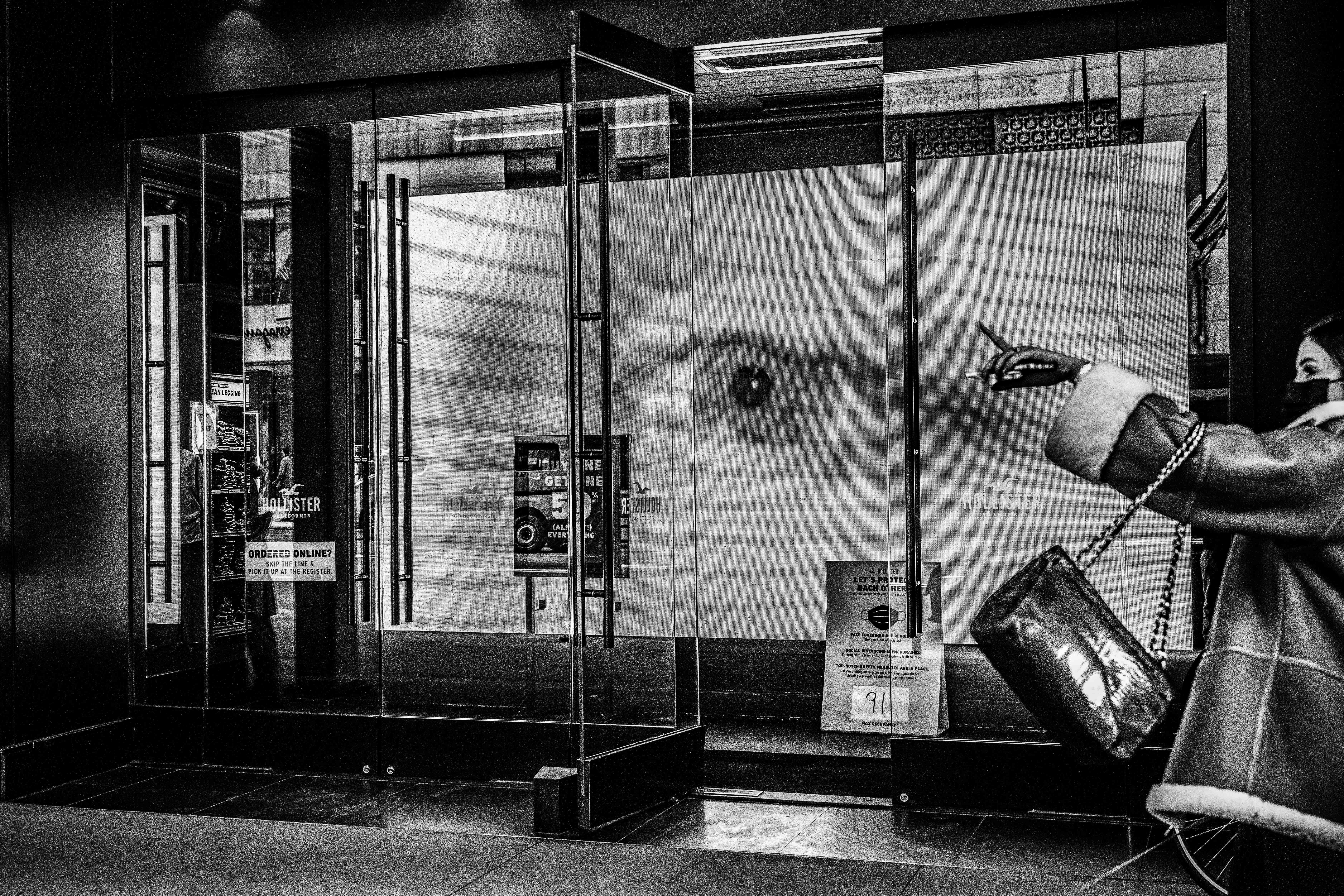 A giant eye looking out from inside a store window.