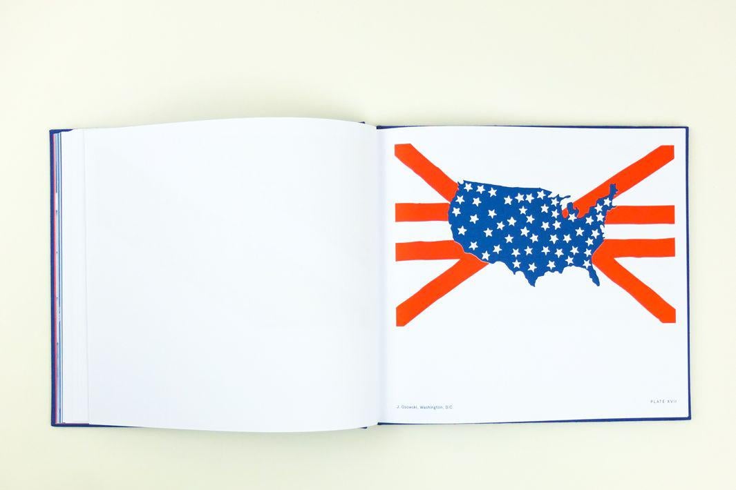 A book showing a flag that centers on a map of the United States with the stars within the borders and the stripes radiating out from it