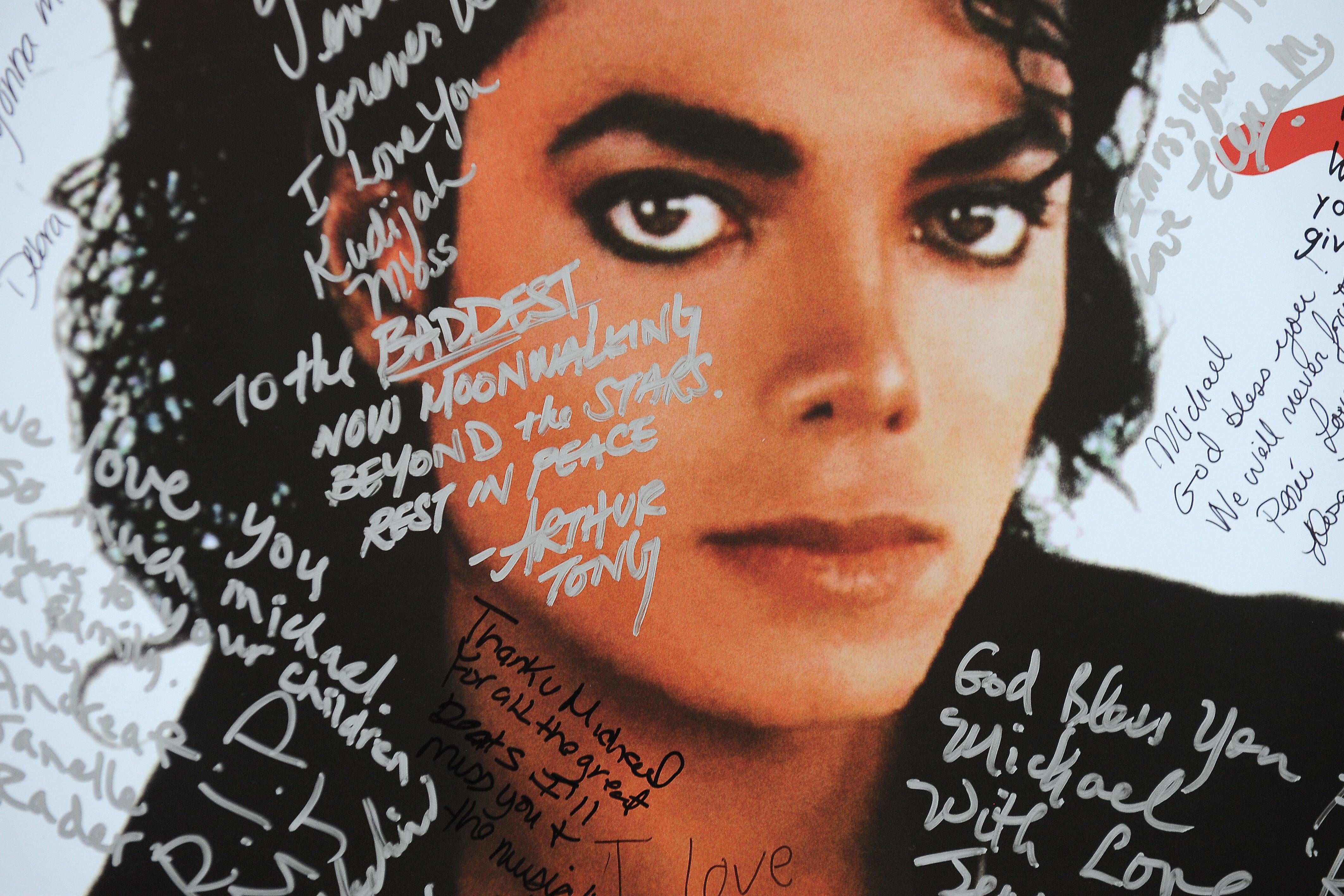 A poster of Michael Jackson with scribbles on it.