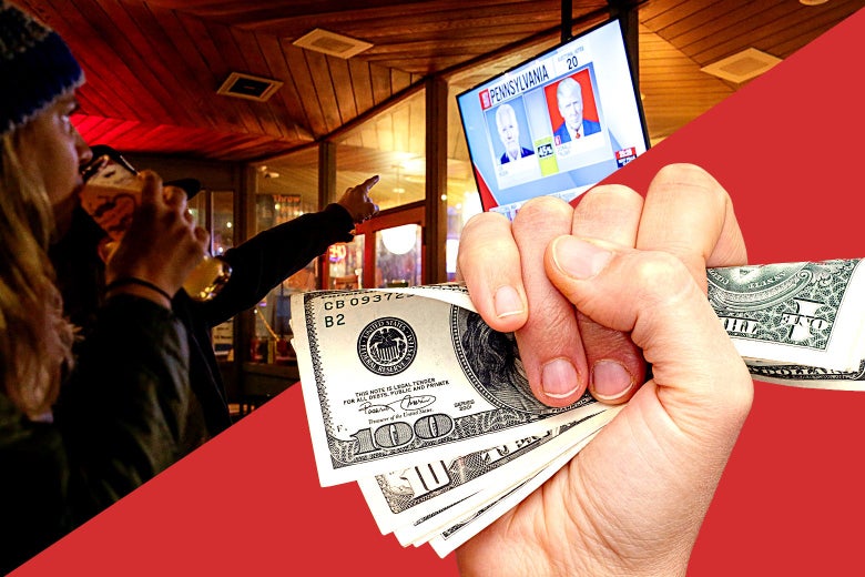 A hand holds onto hundred dollar bills in the foreground while people watch election results in the background.