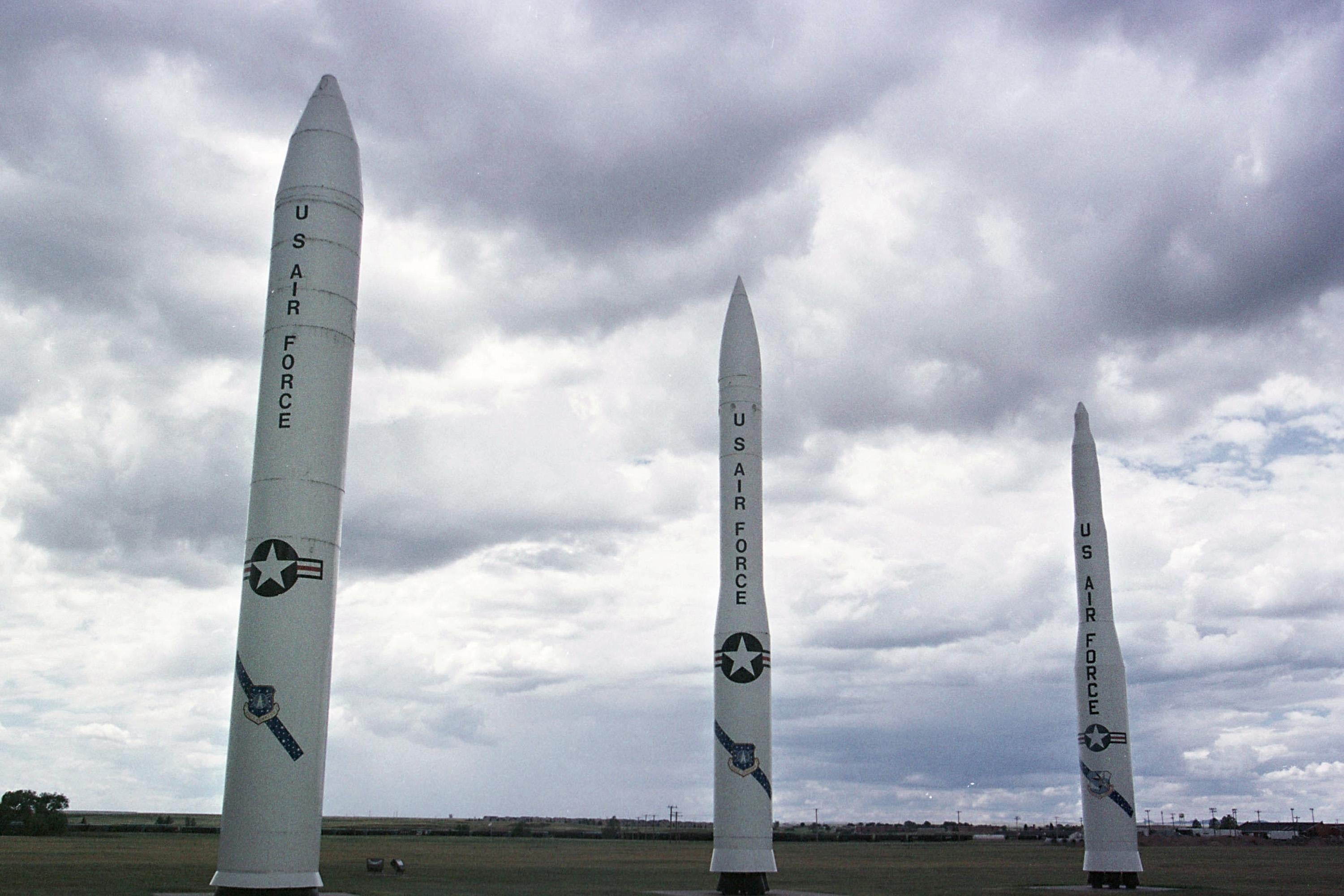 391774 02: A MX or "Peacekeeper" missile, left, and two versions of the Minuteman missile sit at the entrance of Warren Air Force base July 11, 2001 near Cheyenne, WY. Defense Secretary Donald Rumsfeld announced plans to scrap all 50 of the nuclear-tipped missiles located on the base. (Photo by Michael Smith/Getty Images)