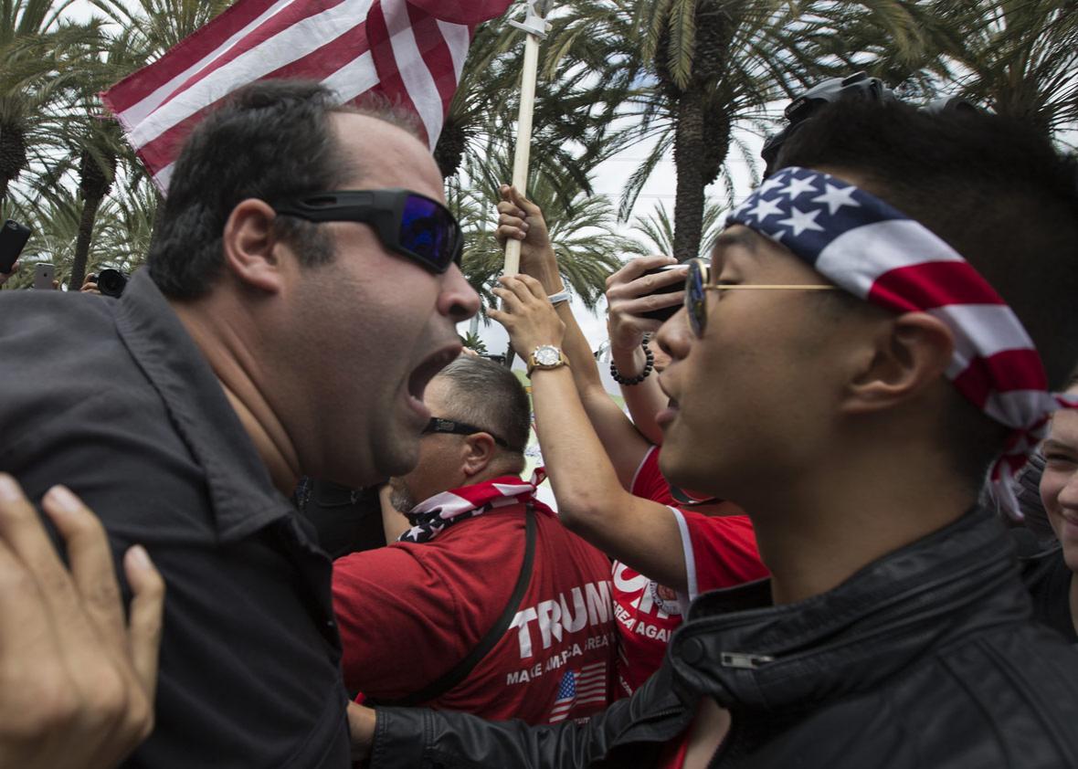 An anti-Trump protester (L) and a Trump support clash outside a campaign rally by presumptive GOP presidential candidate Donald Trump at the Anaheim Convention Center on May 25, 2016 in Anaheim, California. 