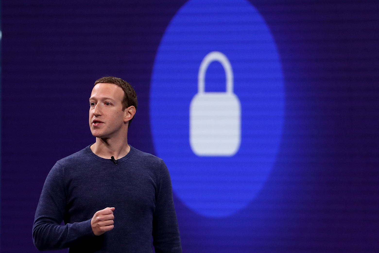 Mark Zuckerberg in front of a slide featuring a padlock icon.