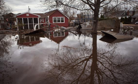 Flooding in Staten Island in the aftermath of Sandy. It would be more cost efficient to build seawalls and "storm doors" for subways than to fight carbon emissions