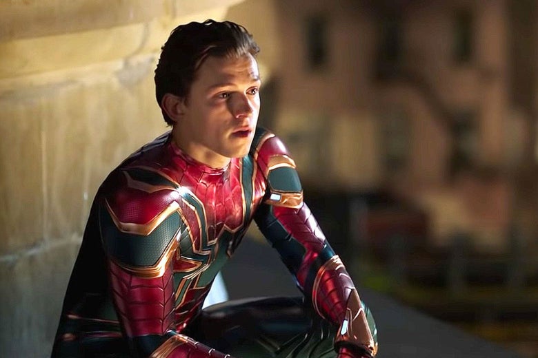 Tom Holland crouches, wearing the Spider-Man costume, in a still from the movie.