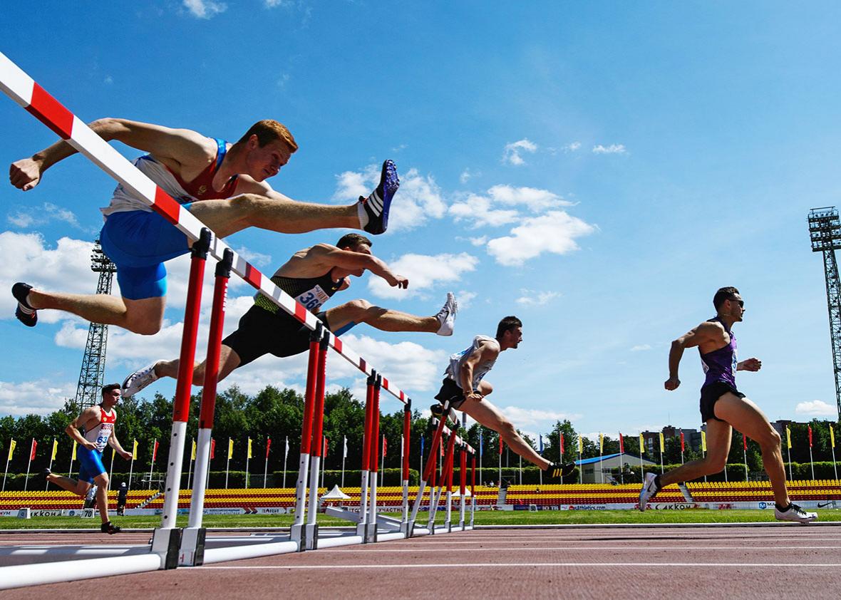 Athletes compete in the men's 110m hurdles event during the 2016 Russian national track and field championships. 