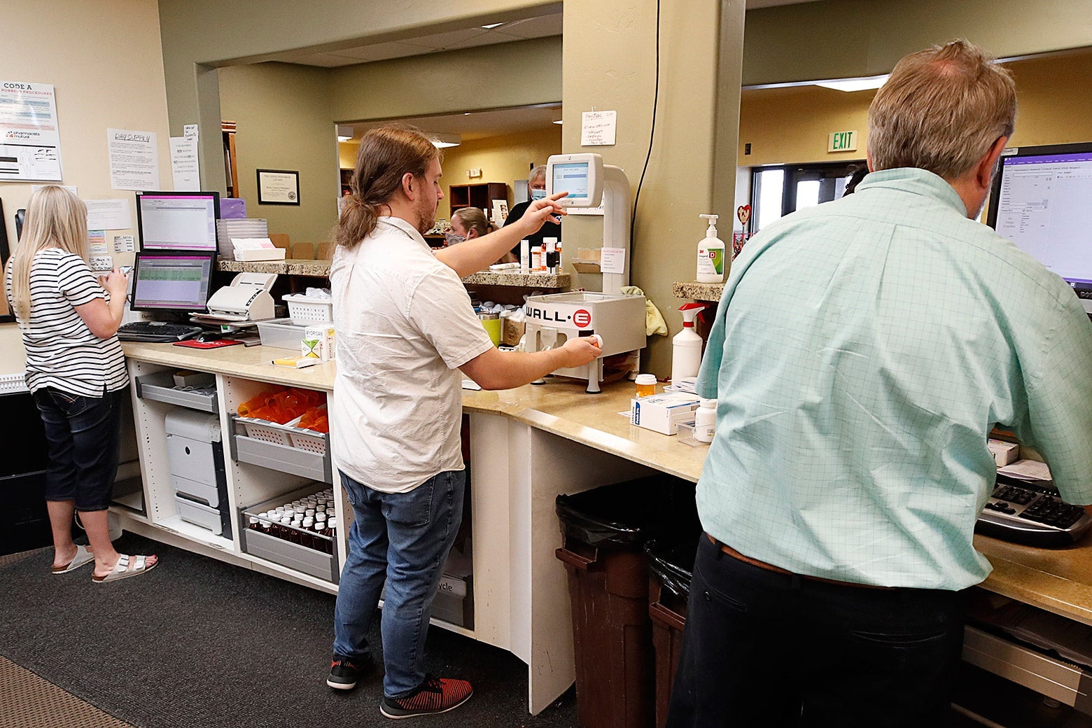 Pharmacists and pharmacy techs fill prescriptions in Provo, Utah.