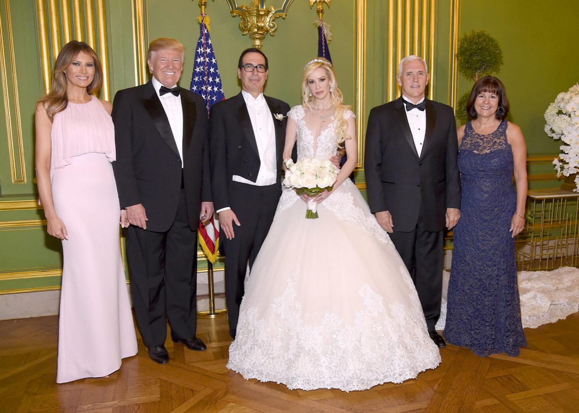 First Lady Melania Trump, President Donald Trump, Secretary of the Treasury Steven Mnuchin, Louise Linton, Vice President Mike Pence, and Second Lady Karen Pence pose at the wedding of Secretary of the Treasury Steven Mnuchin and Louise Linton on June 24, 2017 at Andrew Mellon Auditorium in Washington, DC. Louise Linton is wearing a custom Ines Di Santo gown with wedding ring and earrings by Martin Katz.
