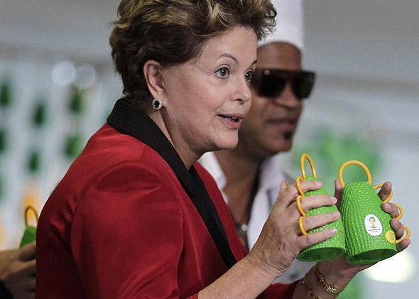 Brazil's President Dilma Rousseff holds the caxirola.