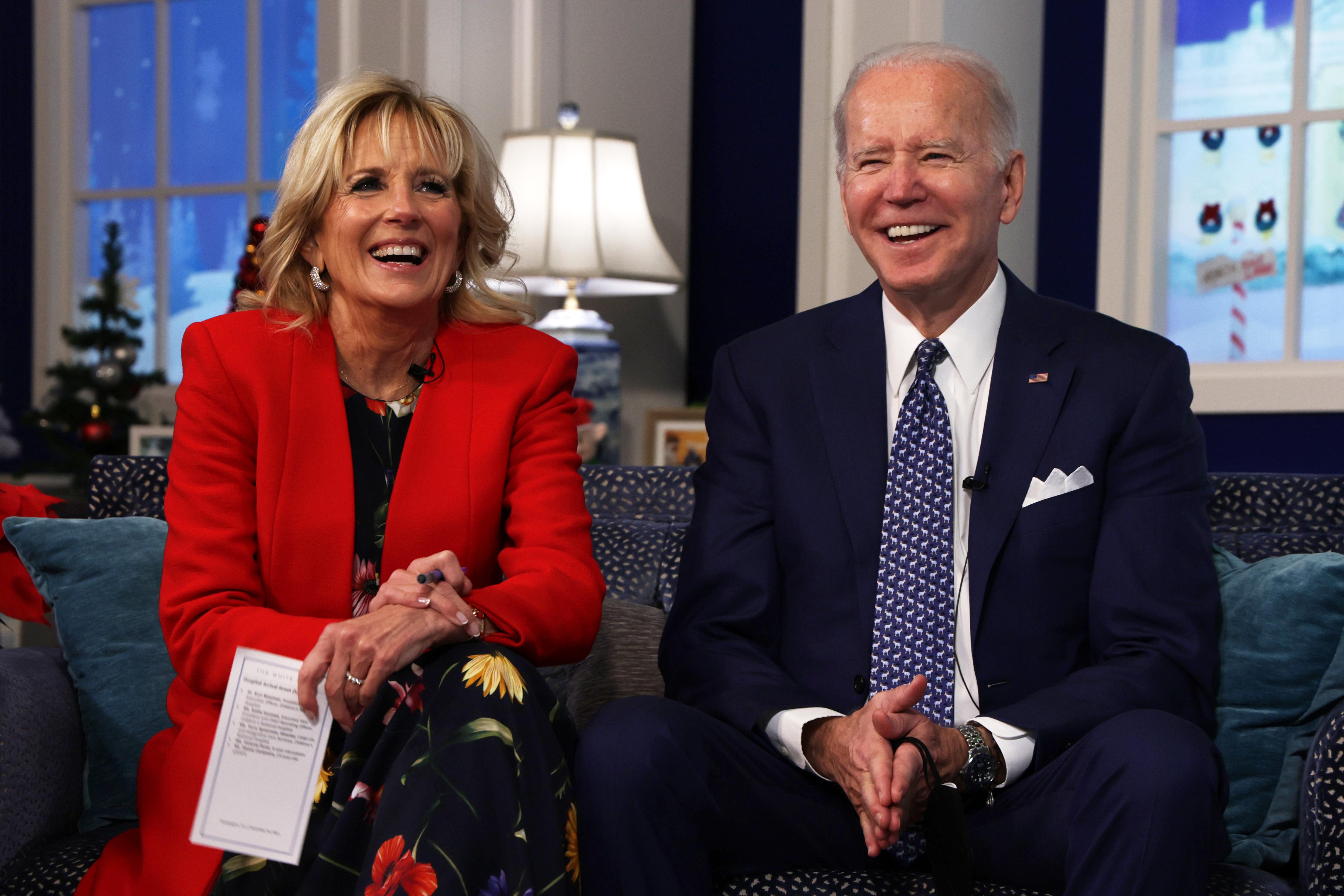 Jill and Joe Biden sitting on a couch smiling broadly