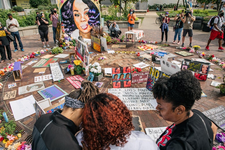 Tamika Palmer, mother of Breonna Taylor is comforted as she looks over a memorial dedicated to her daughter on September 15, 2020 in Louisville, Kentucky. It was announced that the city of Louisville will institute police reforms and pay $12 million to the family for the killing of Breonna Taylor, who was fatally shot by Louisville Metro police officers during a no-knock raid at her apartment on March 13, 2020. (Photo by Brandon Bell/Getty Images)