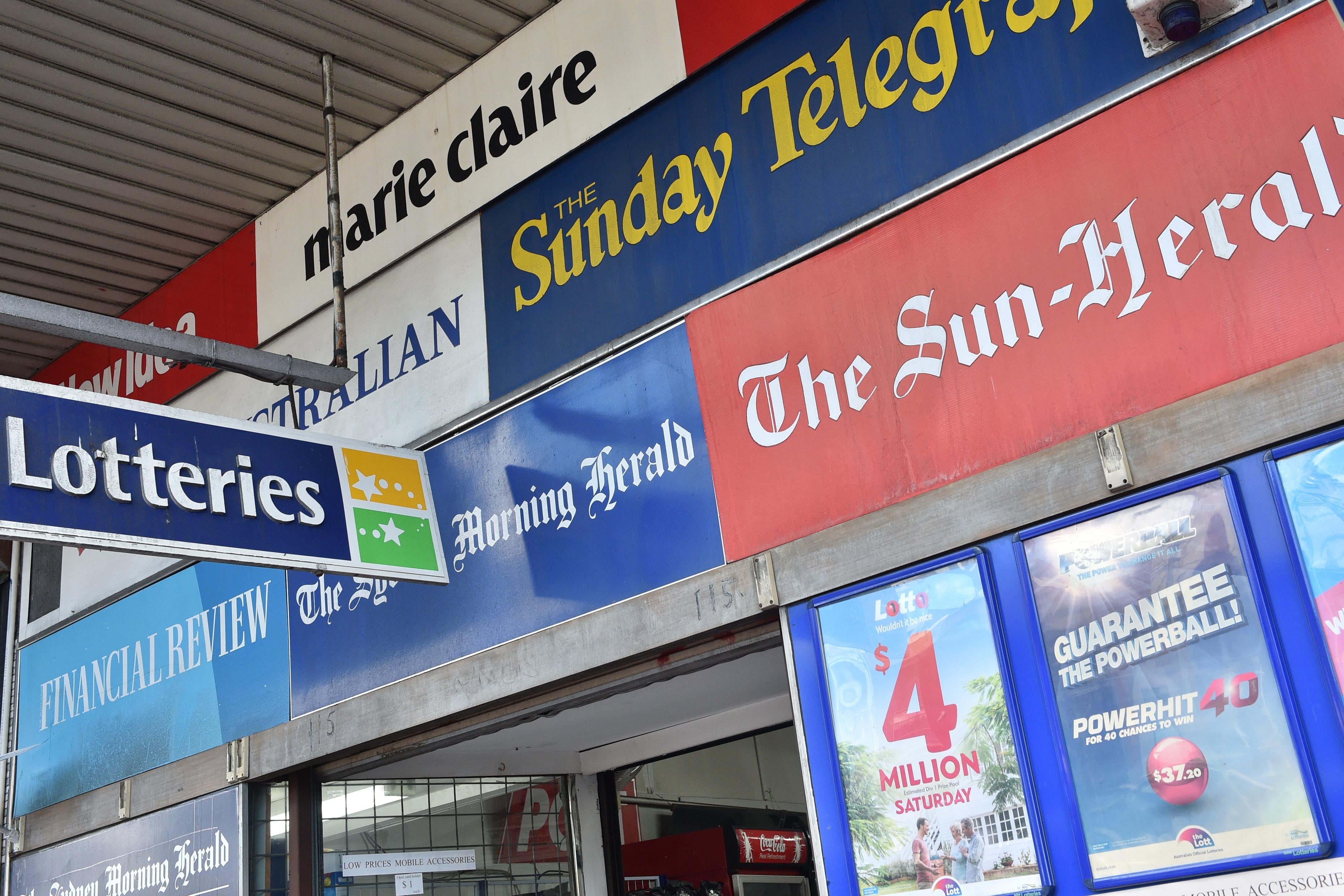 Advertisements for the Sydney Morning Herald, the Sun-Herald, the Sunday Telegraph, and other Australia publications are seen on a building.