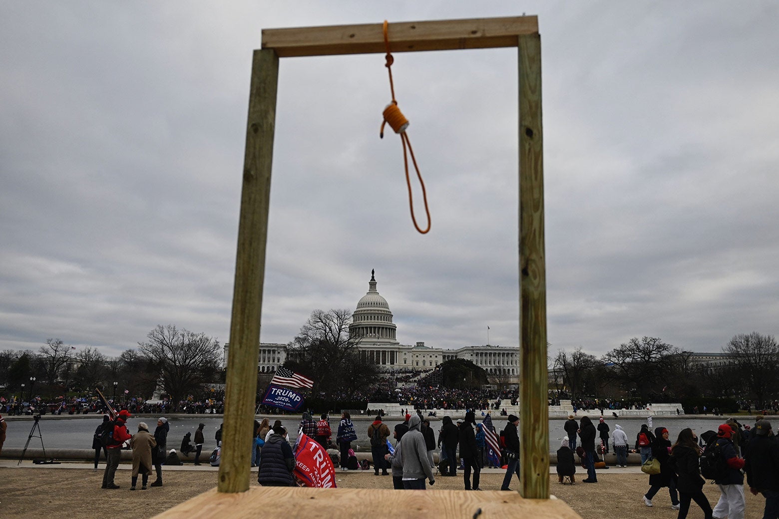 A noose hangs outside the Capitol building. Pro-Trump demonstrators congregate nearby.