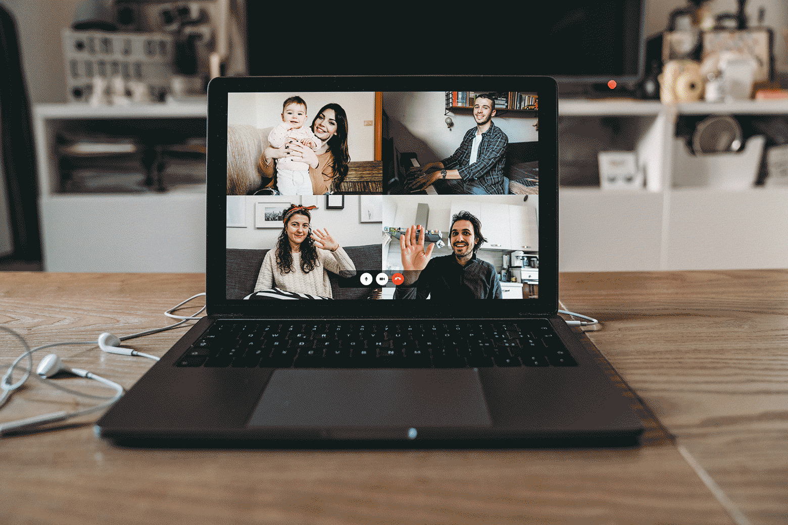 A laptop open to a video chat with four different people. The picture in one of the four screens is laggy and breaking up.