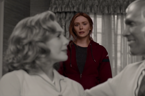 Wanda, in color, gazes at a black-and-white image of herself and her dead husband, Vision, smiling at each other and wearing 1950s clothing