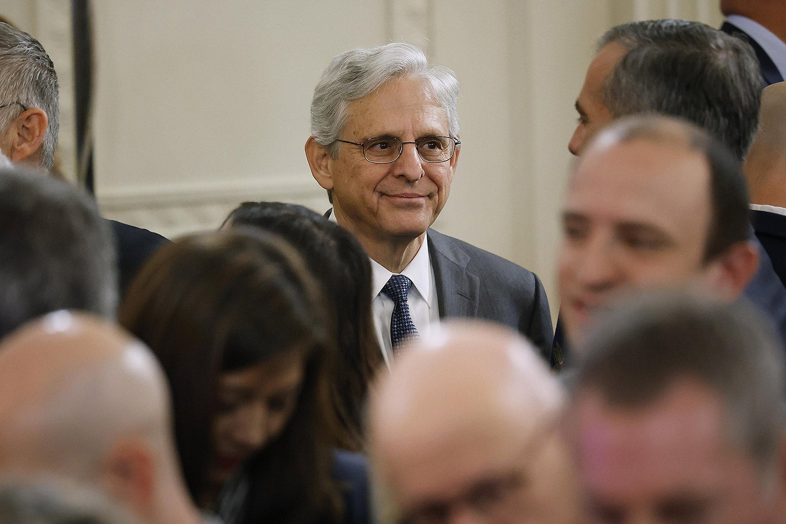 Merrick Garland grinning in a crowd of blurred faces.